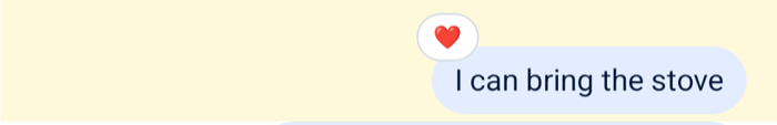 A message with a reaction pill above its bubble on Android